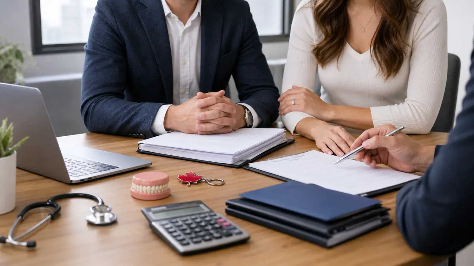 Professional couple reviewing a prenup disclosure package with dental and medical practice items in a Canadian office